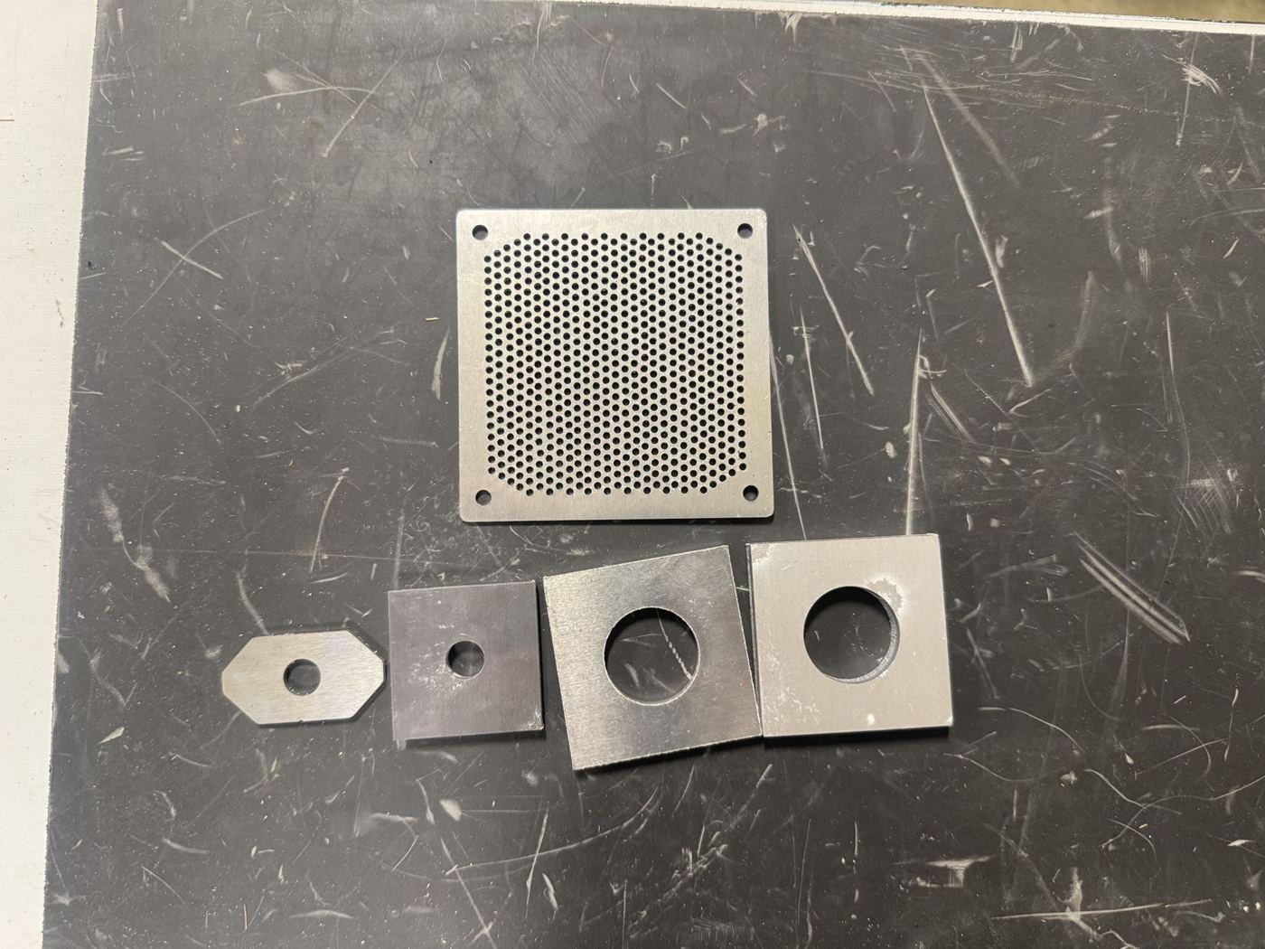 Laser-cut aluminum perforated guard and washers